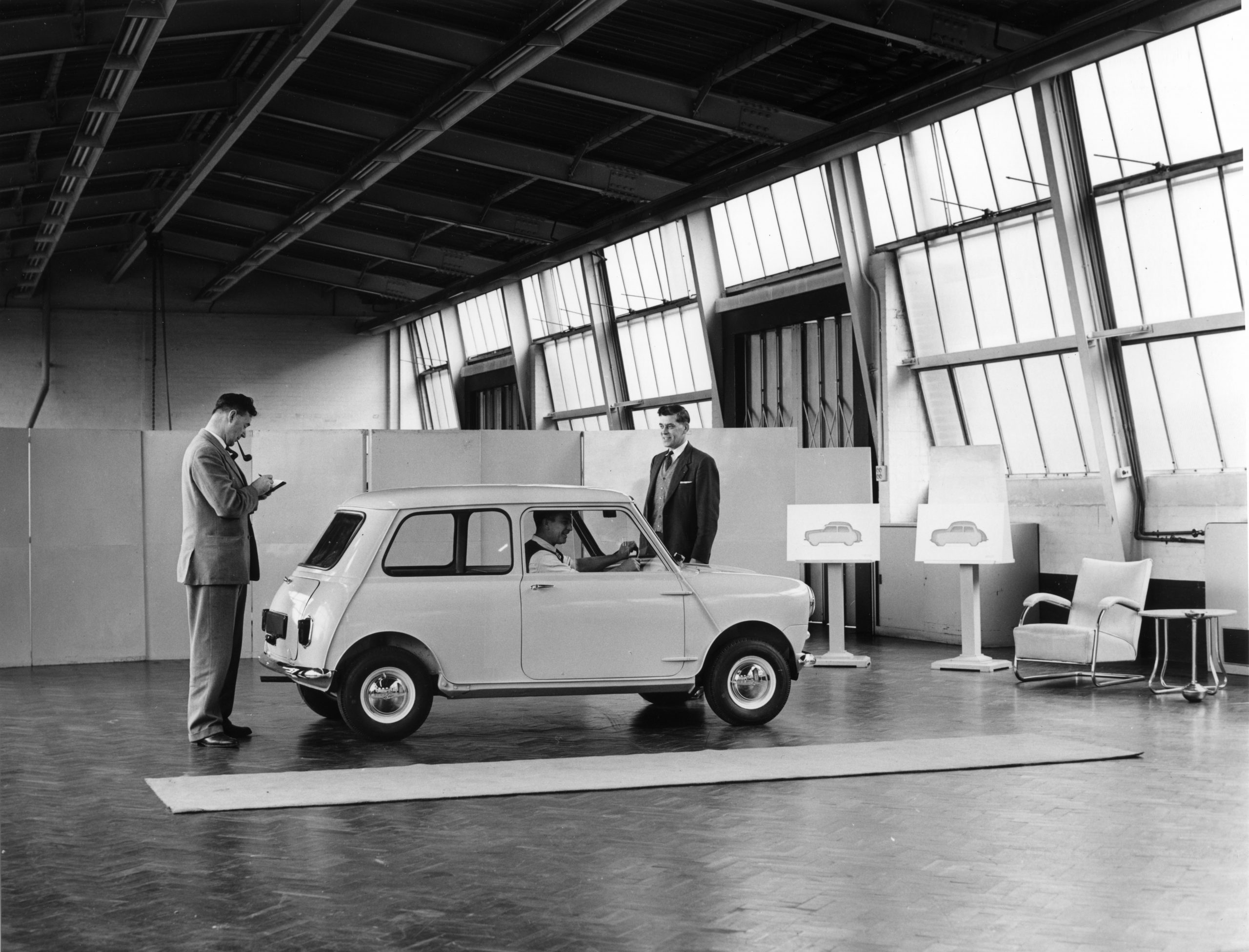 ADO 15 (Mini) 1959. In the Styling Studio at Longbridge being inspected by Jack Daniels. He is comparing it with a Morris Minor an Austin A35 which are on display nearby.