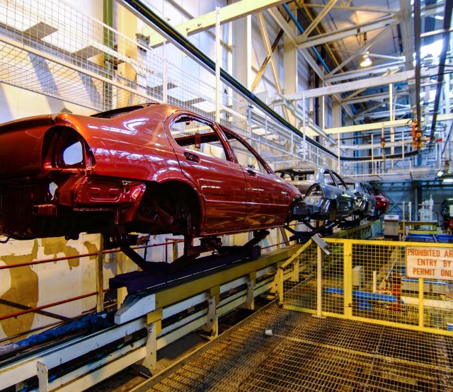 Old MG Rover bodyshells sit on the production line waiting for staff that were fired.